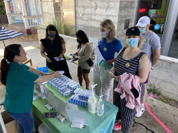 10.1.21_Los Angeles_Crowd at Education Table_Screening Stickers Visible_2 Los Angeles RV visitors sampling sun protection products