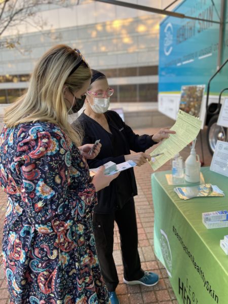 Volunteer Beth G. Goldstein, MD, reviews exam results with a participant in Raleigh.