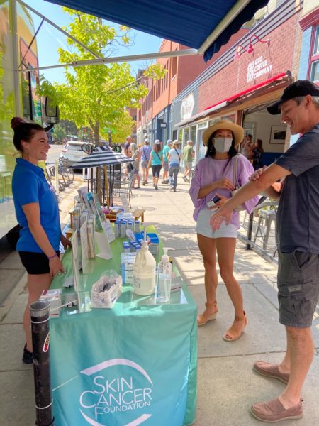 Passersby at our event in Boulder sampling EltaMD sunscreen