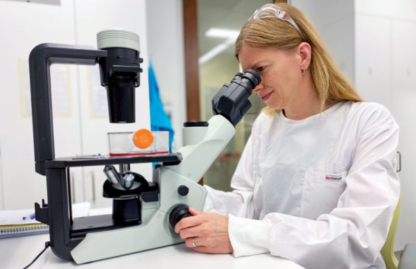 Picture of a woman using a microscope