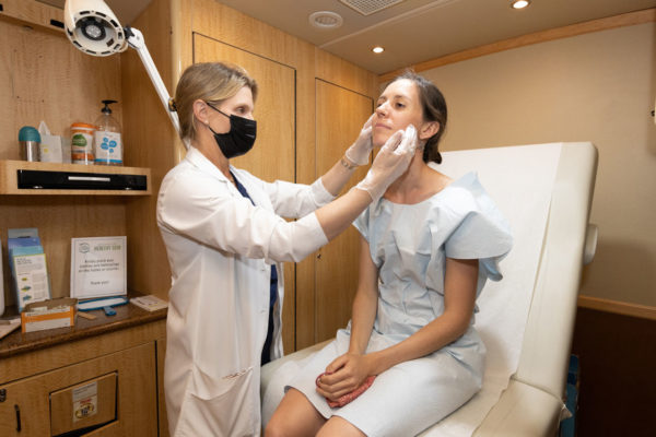 Dr Hale in exam room with Destination Healthy Skin participant