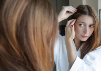 woman examining scalp