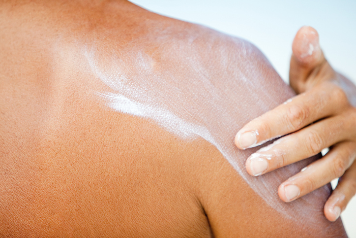 Woman applying sunscreen, Maldives