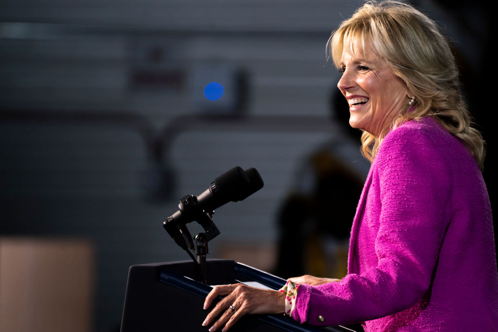 First Lady Jill Biden standing on the podium speaking in front of an audience