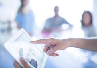 Close up businessman pointing to digital tablet in meeting melanoma staging