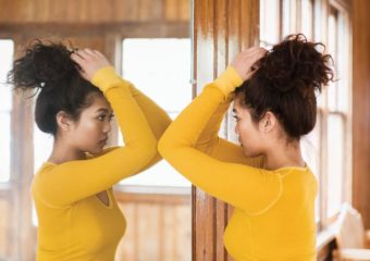 girl looking in the mirror for new changing unusual moles