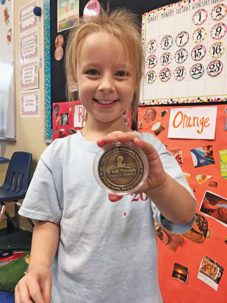 Addison receiving a medal at St Jude's