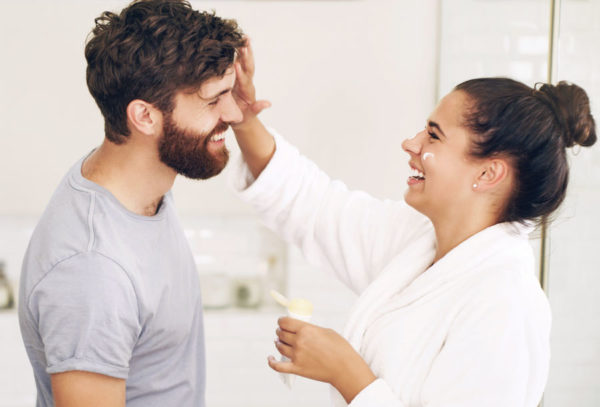 happy duo applying sunscreen