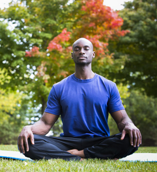 man practicing mindfulness on yoga mat