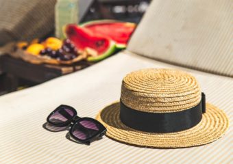 hat sunglasses sun protection with grapes in background