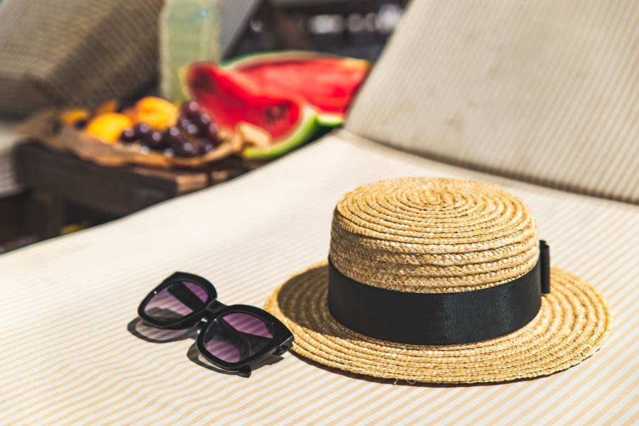 hat sunglasses sun protection with grapes in background