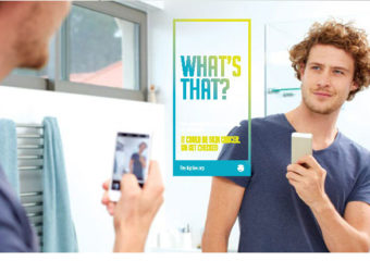 young man looking at the mirror holding a cellphone